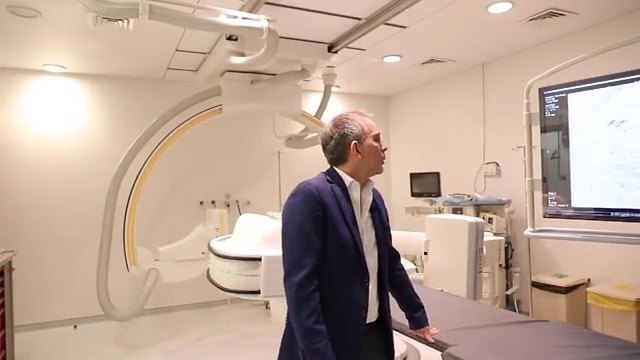 Dr Kabalane Yammine reading the wall monitors during a procedure
