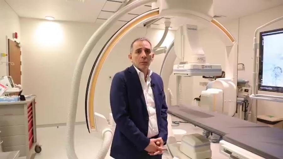 Dr Kabalane Yammine standing inside the imaging arm of the angiography suite at Clemenceau Medical Center